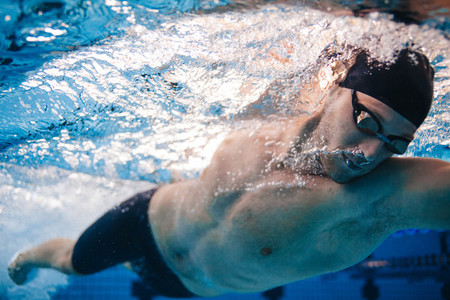 Professional male swimmer inside swimming pool