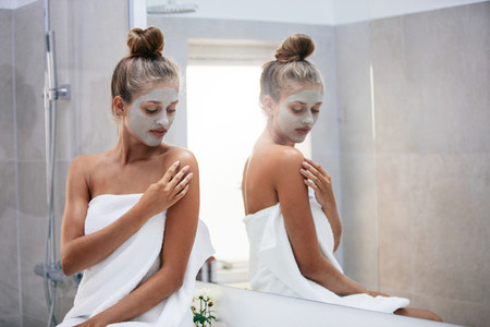 Woman doing skin treatment after bath