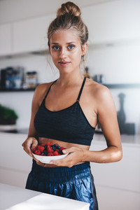 Woman having healthy breakfast in kitchen