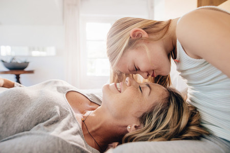 Loving mother and daughter in bedroom