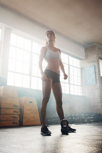 Fitness woman standing in crossfit gym
