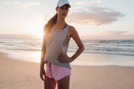 Female fitness model on the sea shore in morning