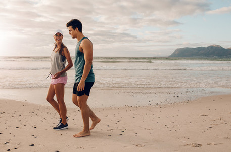 Young couple on walking along the shore
