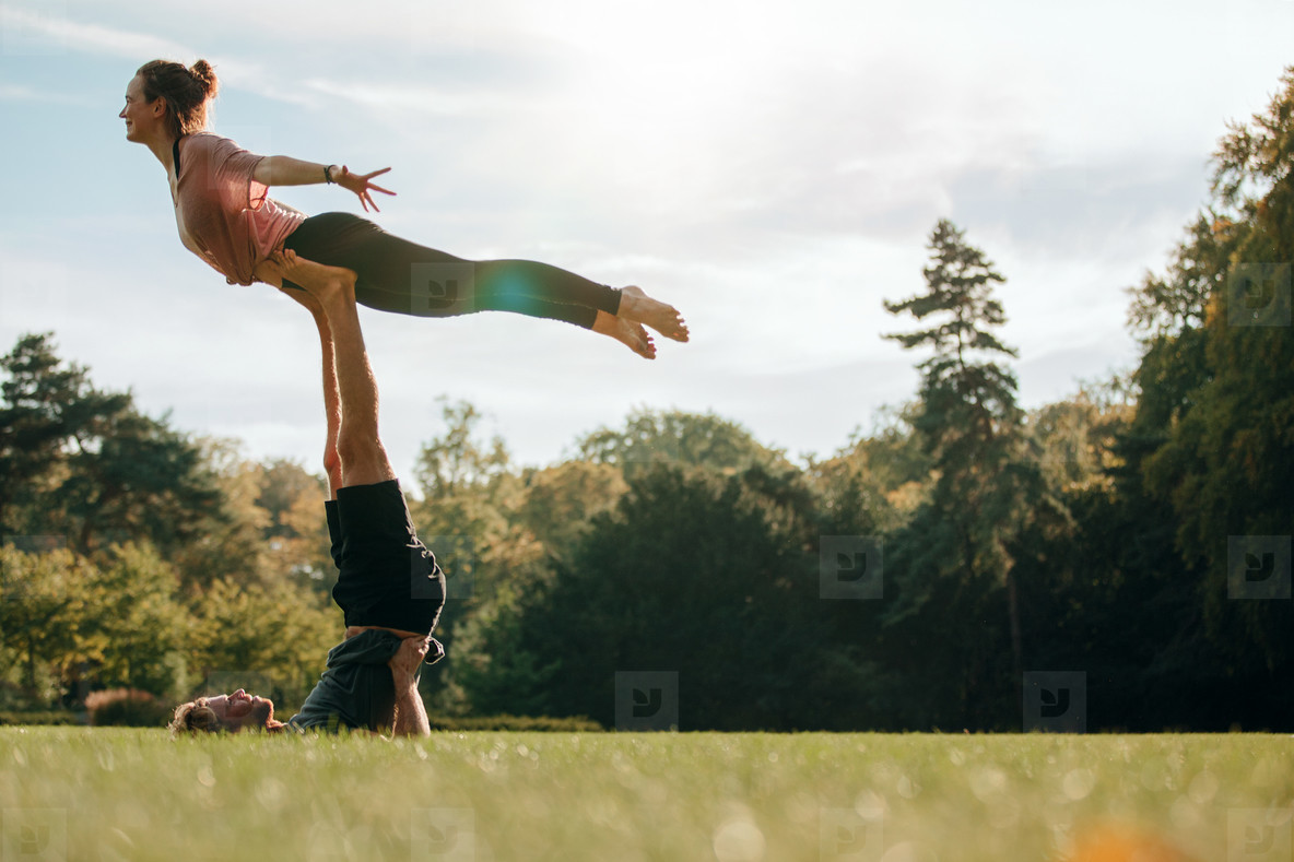 Fit young couple practising acroyoga