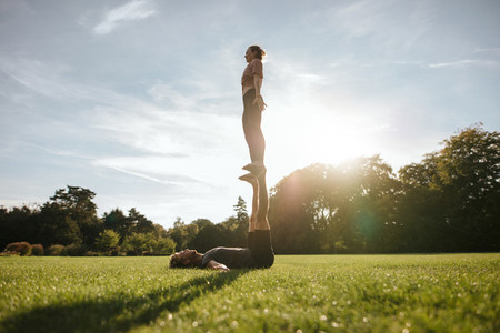 Fit couple doing acrobatic yoga exercise