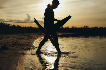 Young man going for spearfishing at evening