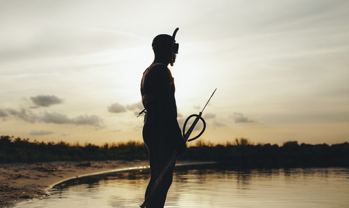 Male diver with speargun ready for underwater fishing
