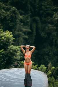 Female model in swimwear posing in pool
