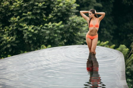 Bikini model posing in pool