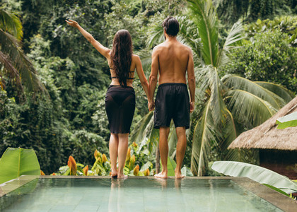 Couple at poolside looking at a view