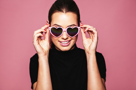Stylish young woman posing with funky shades