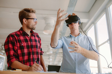 Young men testing virtual reality goggles