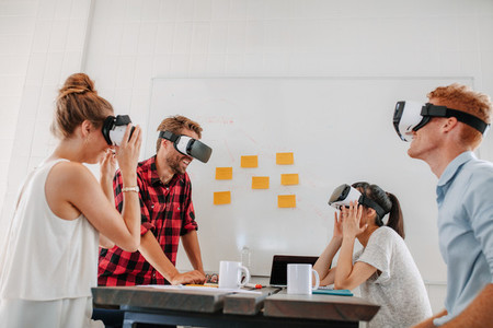 Business team using virtual reality headset in meeting