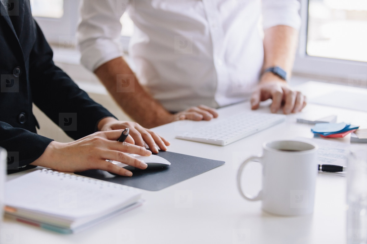 Two business associates working together at office desk