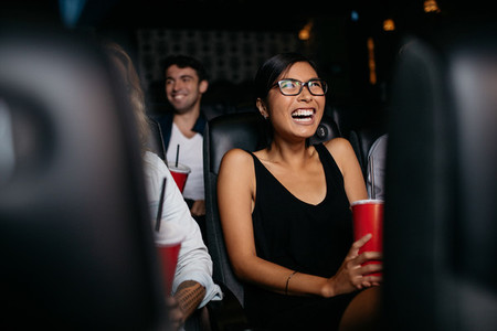 Woman watching movie in theater
