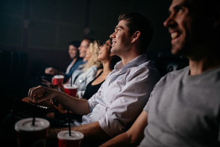 People sitting in cinema hall watching movie