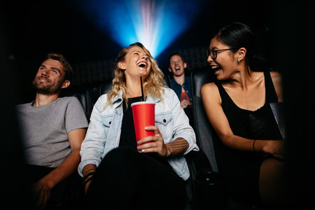 Group of people watching comedy movie in theater