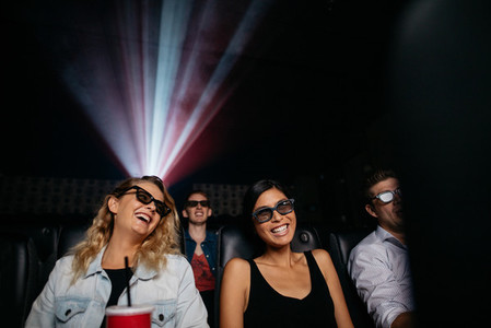 Young women watching 3d movie in cinema