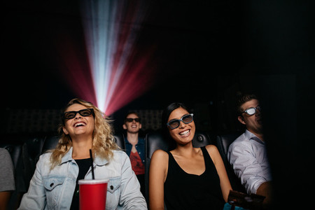 Young women watching 3d movie in theater