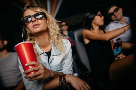 Woman watching 3d movie in theater