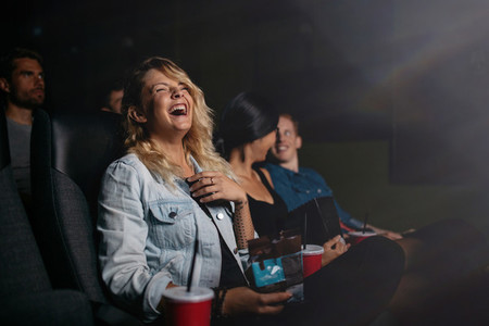 Young people watching movie and laughing