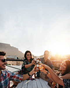 People celebrating with drinks at rooftop party