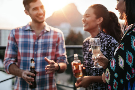 Friends together on rooftop with drinks