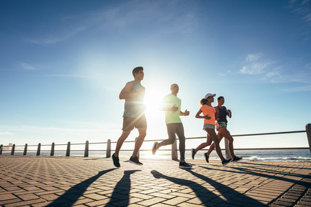 Runners training outdoors by the seaside