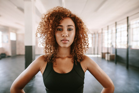 Beautiful afro american female with curly hair in gym