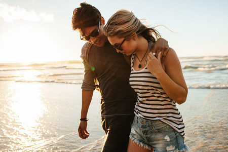Young couple walking on the seashore