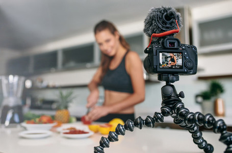 Young female blogger recording content for videoblog in Kitchen
