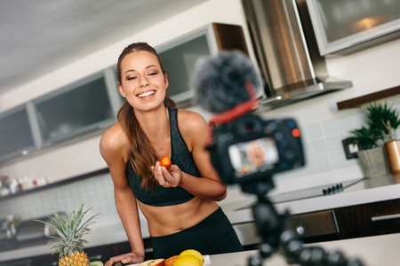 Young woman recording content for her blog in kitchen