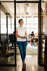 Woman having coffee break at startup