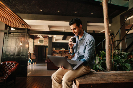 Executive using laptop during coffee break