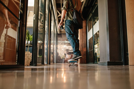 Young man skating through his startup office