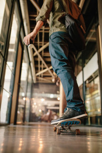 Man skateboarding in office corridor