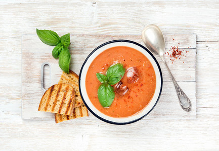 Cold gazpacho tomato soup in bowl with toasted bread