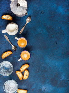 Coffee espresso  cookies and milk over dark blue background  vertical