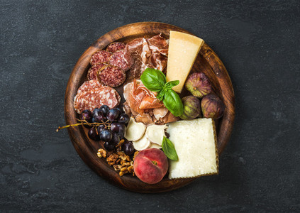 Italian antipasti snacks variety for wine on wooden tray