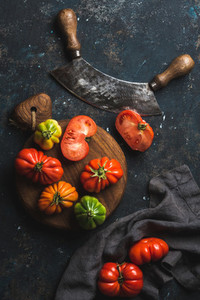 Fresh colorful ripe heirloom tomatoes on wooden board