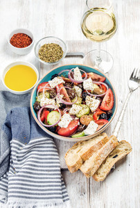 Greek salad with olive oil bread slices spices white wine