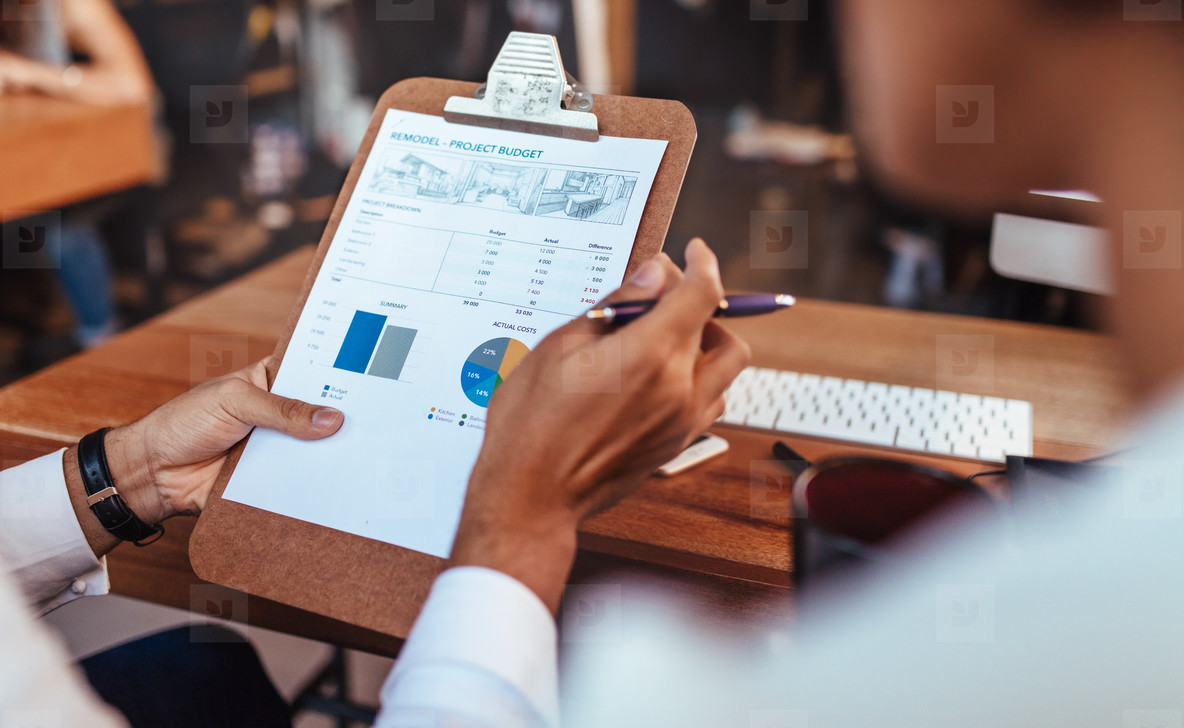 Business people analyzing statistical charts in office
