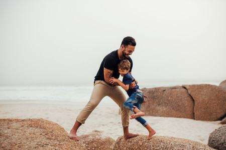 Father playing with son on the beach