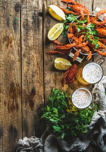 Wheat beer and boiled crayfish over old wooden rustic background