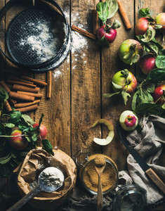 Ingredients for cooking apple pie over rustic wooden background