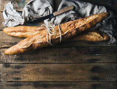 French baguettes on rough rustic wooden background