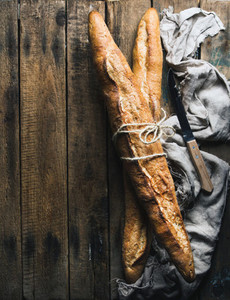 French baguettes on rough rustic wooden background