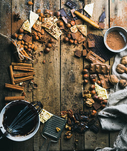 Hot chocolate cooking ingredients over rustic wooden background copy space