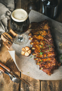 Roasted pork ribs with garlic rosemary and glass of beer