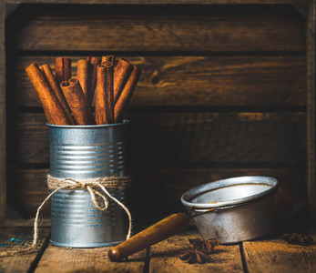 Cinnamon sticks in can tied with rope  anise and sieve